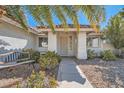 View of a home's entrance, with a metal security door and desert landscaping at 914 Calico Brook Dr, Henderson, NV 89002