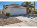Exterior view of a two-car garage with desert landscaping and a driveway at 914 Calico Brook Dr, Henderson, NV 89002