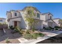 Charming two-story home with a desert landscape, a two-car garage and a warm, inviting front entrance at 9233 Far Side Ave, Las Vegas, NV 89143