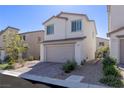 Charming two-story home with brick driveway, a two-car garage, and desert-friendly landscaping at 9233 Far Side Ave, Las Vegas, NV 89143
