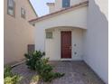 Inviting home featuring a beautiful, paneled front door and desert-friendly landscaping at 9233 Far Side Ave, Las Vegas, NV 89143