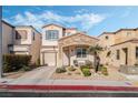 Charming two-story home with stone accents, desert landscaping, and an attached garage at 10435 Meadow Village St, Las Vegas, NV 89183