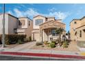 Charming two-story home with stone accents, desert landscaping, and an attached garage at 10435 Meadow Village St, Las Vegas, NV 89183