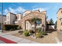 Charming two-story home with stone accents, desert landscaping, and an attached garage at 10435 Meadow Village St, Las Vegas, NV 89183
