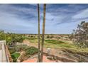 Expansive view from the balcony overlooking lush greenery, mature trees, and neighborhood rooftops at 138 Wentworth Dr, Henderson, NV 89074