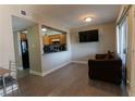 A modern living room with wood floor and a view of the kitchen through the pass through at 1467 Hialeah Dr # D, Las Vegas, NV 89119