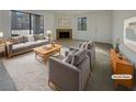 Bright living room with a cozy fireplace and large windows that fill the space with natural light, perfect for relaxation at 1575 W Warm Springs Rd # 1111, Henderson, NV 89014