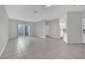 Bright living room with tile flooring, ceiling fan, and an open layout leading to the kitchen at 1807 Rapier Dr # 1807, Henderson, NV 89014