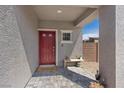 Inviting front porch with a covered entrance, brick flooring, a decorative bench, and a 'Welcome' mat at 1876 Jamie Brook Pl, North Las Vegas, NV 89084