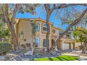 Two-story home with mature trees and a three-car garage at 20 High Sierra Dr, Henderson, NV 89074