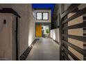A modern, gated front entrance leads to the home's stylish front door at 2861 Queens Courtyard Dr, Las Vegas, NV 89109