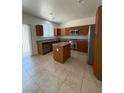 Kitchen with a center island, tile floors, and stainless steel appliances at 3104 Naggio Shores Ave, Las Vegas, NV 89141