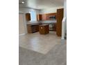 Kitchen with a center island, tile floors, stainless appliances, and carpeted area at 3104 Naggio Shores Ave, Las Vegas, NV 89141