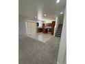 Open-concept living room and kitchen with tile and carpet flooring at 3104 Naggio Shores Ave, Las Vegas, NV 89141