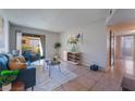 Cozy living room features a blue sofa set and sliding door to a patio, offering a blend of comfort and style at 3151 Soaring Gulls Dr # 2113, Las Vegas, NV 89128