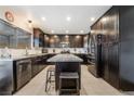 A spacious kitchen features dark cabinets, stainless steel appliances, and granite countertops at 3920 Clear View Dr, Las Vegas, NV 89121