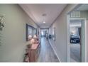 Inviting hallway with stylish wood-look tile flooring leading to various rooms at 5360 S Chippewa St, Pahrump, NV 89061
