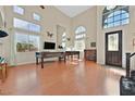 Bright living room with high ceilings, large windows, and beautiful wood floors at 6116 Golden Saddle St, Las Vegas, NV 89130