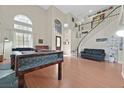 Spacious living room featuring high ceilings, ample natural light, and an elegant staircase at 6116 Golden Saddle St, Las Vegas, NV 89130