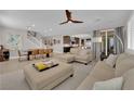 Open-concept living room with dining area and modern finishes throughout the house at 7584 Sweet Mist Ave, Las Vegas, NV 89178
