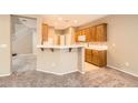 Kitchen area featuring bright white countertops, breakfast bar, and staircase view at 8065 Starling View Ct, Las Vegas, NV 89166