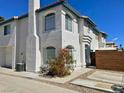 A two-story white townhouse with a stucco exterior and blue trim at 8160 Autumn Star Ave, Las Vegas, NV 89145