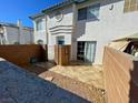 A brick-walled patio with a stone walkway leading to a sliding glass door at 8160 Autumn Star Ave, Las Vegas, NV 89145