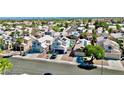 Expansive aerial view of a neighborhood, showcasing well-maintained homes, manicured lawns, and proximity to city skyline at 8233 Hydra Ln, Las Vegas, NV 89128