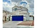Attractive two-story house with a vibrant blue garage door, enhanced by neat landscaping and a welcoming driveway at 8233 Hydra Ln, Las Vegas, NV 89128