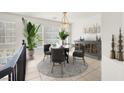 Cozy dining area featuring a round table, stylish chairs, and plenty of natural light from large windows at 8426 Sluman Ct, Las Vegas, NV 89128
