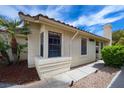 Exterior side view showcasing manicured shrubs and a tiled roof, providing charming curb appeal at 8582 Manalang Rd, Las Vegas, NV 89123