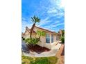 Beautiful exterior view showcasing a terracotta tiled roof, complemented by tropical palm trees at 8582 Manalang Rd, Las Vegas, NV 89123