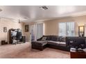 Comfortable living room with a large sectional sofa and natural light from sliding glass doors at 8600 W Charleston Blvd # 2190, Las Vegas, NV 89117