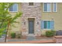 Welcoming townhome with stone accents, fresh landscaping, and a cozy entrance at 965 Nevada State Dr # 8202, Henderson, NV 89002