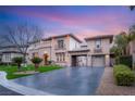 Elegant two-story home featuring well-manicured lawn and a spacious driveway at 10412 Mansion Hills Ave, Las Vegas, NV 89144