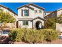 Charming two-story home featuring neutral stucco, arched entry, shutters, and a well-maintained front yard at 10604 Sariah Skye Ave, Las Vegas, NV 89166