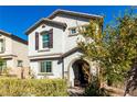 Charming two-story home featuring neutral stucco, arched entry, shutters, and a well-maintained front yard at 10604 Sariah Skye Ave, Las Vegas, NV 89166