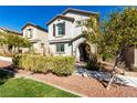 Charming two-story home featuring neutral stucco, arched entry, shutters, and a well-maintained front yard at 10604 Sariah Skye Ave, Las Vegas, NV 89166