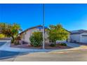 Well-kept single-story home with a two-car garage, nestled in a quiet residential area with mature trees at 1809 Lazy Hill Ranch Way, North Las Vegas, NV 89081