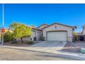 Inviting single-story home boasts a two-car garage and neat landscaping, set in a peaceful neighborhood at 1809 Lazy Hill Ranch Way, North Las Vegas, NV 89081