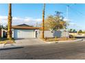 Charming single-story home with a white garage door and well-kept front yard under a bright sky at 2500 Holly Ave, Las Vegas, NV 89106