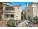 Beautiful condo complex with lush landscaping, blue railings, and well-maintained grounds at 2725 S Nellis Blvd # 1033, Las Vegas, NV 89121