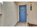 Charming blue front door with decorative hardware and updated exterior lighting at 2725 S Nellis Blvd # 1033, Las Vegas, NV 89121
