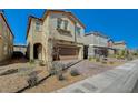 Charming two-story home with desert landscaping, paved driveway, and attached two-car garage at 3164 Bormida Ave, Henderson, NV 89044