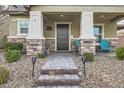 Inviting front porch with stone accents, elegant columns, and a cozy seating area for relaxation at 3177 Bivona Walk, Henderson, NV 89044