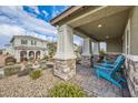 Comfortable front porch seating with a covered patio, offering a perfect spot to unwind at 3177 Bivona Walk, Henderson, NV 89044