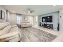 Spacious living room featuring modern furnishings, a ceiling fan, and stylish flooring at 3177 Bivona Walk, Henderson, NV 89044