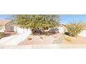 Charming single-story home with low maintenance desert landscaping, and a two car garage at 327 Perry Ellis Dr, Henderson, NV 89014