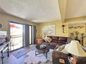 Cozy living room featuring a plush sectional sofa and access to a private balcony at 3740 Desert Marina Dr # 3, Laughlin, NV 89029