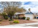 Charming two-story home with a well-maintained front yard, xeriscaping, and a two car garage at 4322 Satinwood Dr, Las Vegas, NV 89147